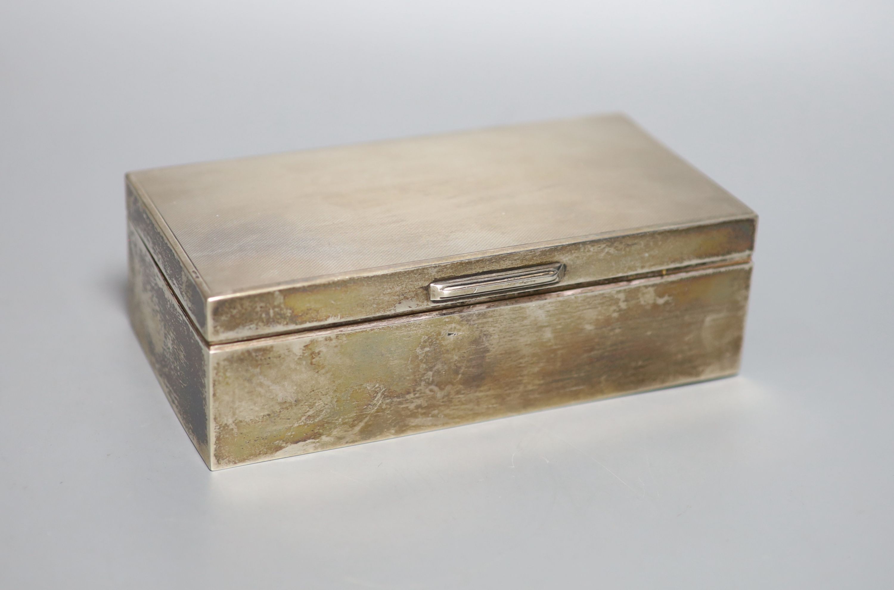 A pair of Edwardian silver vases, Birmingham, 1908, 11.1cm, weighted, four modern silver wine labels and a silver mounted cigarette box.